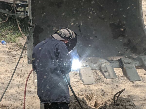 Mobile Metalworks LLC in action Mobile Metalworks LLC owner Daniel Pham welding heavy equipment