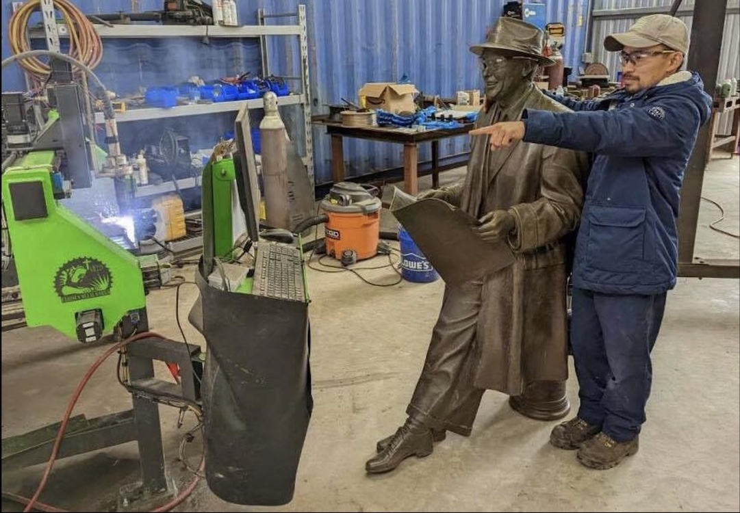 Daniel Pham with statue repair work in shop